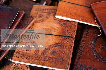 India,Rajasthan,Jaisalmer. In Jaiselmer Fort market,beautifully worked leather book covers for sale in various sizes and decorative styles.