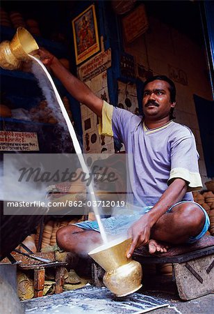 Preparing sweet milk in a stall on the streets of Barabazaar in North Kolkata