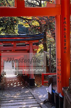 Japan,Honshu Island,Kyoto. Fushimi Inari Taisha is a shrine dedicated to Inari,the Shinto Rice God. This Shrine actually has five shrines spread across its grounds,which also have about 10,000 Torii (gates),each donated by worshippers or companies whose name and addresses are written on the back.