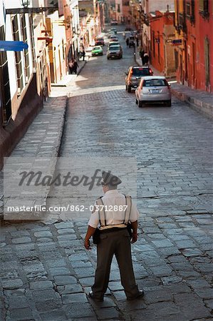 A policeman directing traffic on a street in San Miguel, Mexico