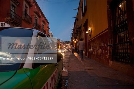 A taxi driver in San Miguel de Allende Mexico sits in his car waiting for a fare