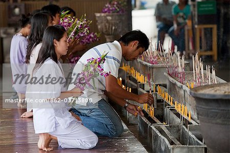 Bangkok, Thailand. Praying at a buddhist temple