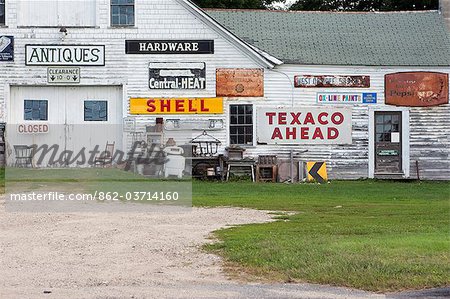An old barn covered in gas station signs in New England, Maine