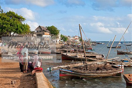 Kenya. Lamu s busy waterfront with numerous dhows anchored in the harbour.