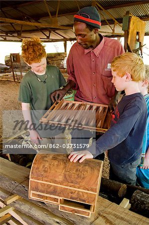 Kenya, Laikipia, Lewa Downs. A craftsmen at the Wilderness Trails community workshop, backgammon board inlaid with acacia root. Kenya, Laikipia, Lewa Downs. A craftsmen at the Wilderness Trails community workshop, backgammon board inlaid with acacia root.