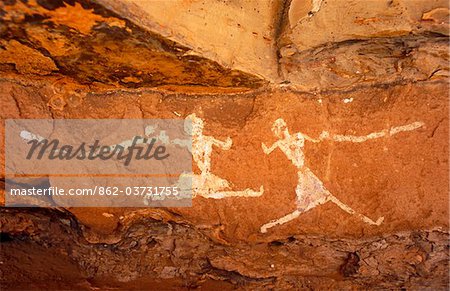 Libya, Fezzan, Jebel Akakus. A pair of running figures painted onto the walls of Uan Muhuggiag, one of Wadi Teshuinat's caves.