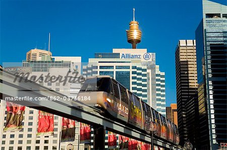 Australia, New South Wales, Sydney.  Monorail at Darling Harbour with the city skyline beyond.