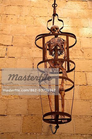 Malta, Mdina. Gibbet with skelton, hanging outside the Mdina dungeon museum.