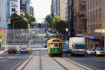 Australia, Victoria, Melbourne.  A tram trundles along the streets of downtown Melbourne.