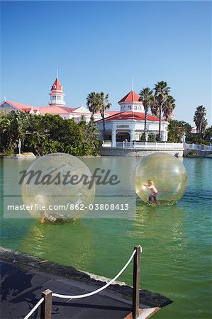 Children playing in inflatable balls on lake at the Boardwalk entertainment complex, Summerstrand, Port Elizabeth, Eastern Cape, South Africa