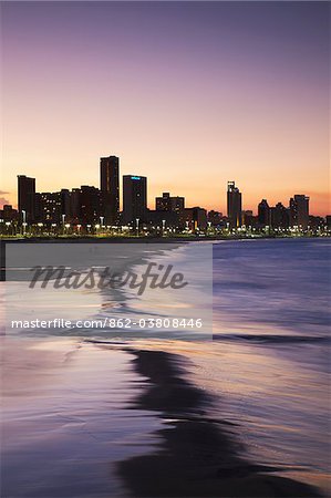 View of city skyline and beachfront at sunset, Durban, KwaZulu-Natal, South Africa