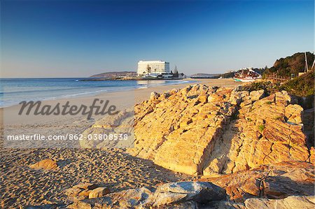 Plettenberg Bay beach at dawn with Beacon Island Hotel in background, Western Cape, South Africa