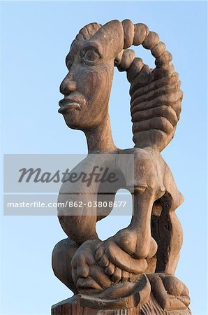 A wood carving which stands on a pillar beside the main entrance to the harbour at Bagamoyo.