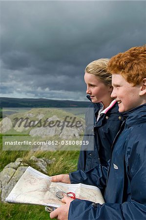 UK, North Wales, Snowdonia.  Two children map reading whilst out hiking.
