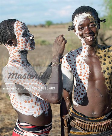 The Karo excel in body art. Before dances and ceremonial occasions, they decorate their faces and torsos elaborately using local white chalk, pulverised rock and other natural pigments.  Young men like their hair braided in striking styles.The Karo are a small tribe living in three main villages along the lower reaches of the Omo River in southwest Ethiopia.