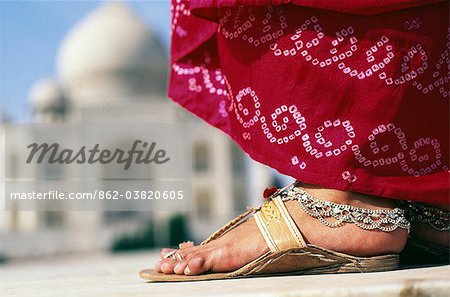 Indian foot & sari detail in front of the Taj Mahal, Agra.The Taj Mahal was built by a Muslim, Emperor Shah Jahan in the memory of his dear wife and queen Mumtaz Mahal.It is an elegy in marble or some say an expression of a dream.