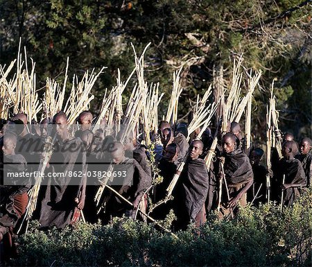 Mothers rub animal fat into their sons cloaks to make them supple. This task is performed shortly before the boys set out on an arduous journey to collect sticks, staves and gum to make bows, blunt arrows and clubs after their circumcision.