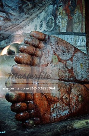 Sri Lanka, Dambulla, Cave Temples.Detail of the feet of a reclining Buddha in one of the Dambulla Caves.Dambulla is a part of the Cultural Triangle declared by UNESCO is on the main road from Sigiriya to Kandy about 19Km from Sigiriya.