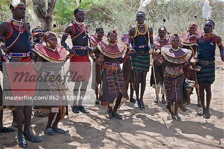 Young Pokot men and women dancing to celebrate an Atelo ceremony. The Pokot are pastoralists speaking a Southern Nilotic language.