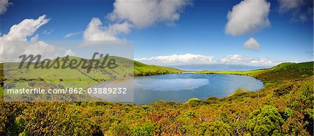 The Lagoa do Caiado crater (Caiado lagoon), one of the undreds of craters spread along the Pico island. On the horizon we can see Sao Jorge island. Azores islands, Portugal