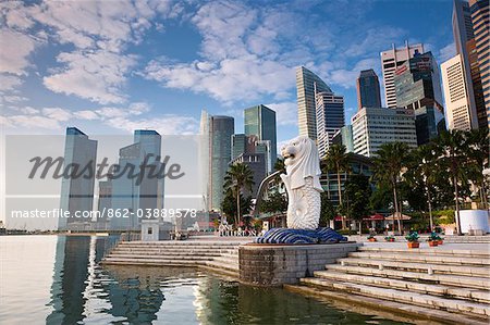 Singapore, Singapore, Marina Bay.  The Merlion Statue with the city skyline in the background, Marina Bay.