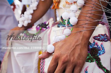 Thailand, Ko Phuket, Phuket.  The arm of a Ma-Thong (spirit medium) pierced by hundreds of metal skewers - during the Phuket Vegetarian Festival.   The festival (known as Jia Chain in local Hokkien Chinese dialect) begins on the first evening of the ninth lunar month (usually in October) and lasts for nine days.