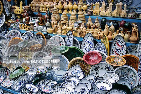 Pottery for sale in local market stall in the town of Kairouan, Tunisia Pottery for sale in local market stall in the town of Kairouan, Tunisia