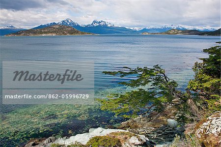 The Beagle Channel with the small Island of Redonda (The Round Island) and snow-capped mountains of Chile in the distance.