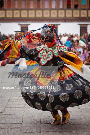 Masked dancing at Trashi Chhoe Dzong, a monastery now also housing the secretariat, the throne room and offices of the King.