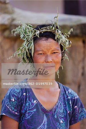 Girl in Sopsokha village wearing a ringlet of grass on her head to protect against the sun.