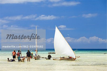 Tanzania, Zanzibar, Unguja Island, Kizimkazi. Fishermen returning with the incoming tide.