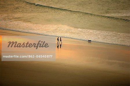 South America, Brazil, Ceara, Jericoacoara, A couple walk along the beach at sunset seen from the Sunset dune