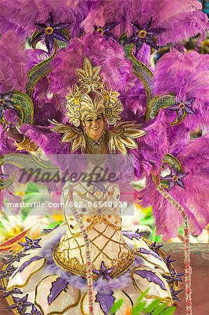 South America, Rio de Janeiro, Rio de Janeiro city, costumed transvestite dancer in a huge feather headdress at carnival in the Sambadrome Marques de Sapucai