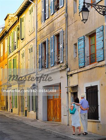 France, Provence, Arles, man and woman walking through oldtown MR