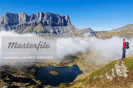 Europe, France, French Alps, Haute Savoie, Chamonix, Servoz valley, hiker above lake MR