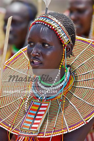 A young Pokot woman sings to celebrate the opening of a new pre primary school at Ngaini, a remote area of the Kerio Valley. Despite her youth, her jewellery denotes she is already married.