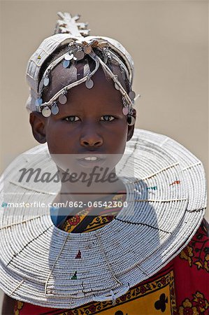 A young Maasai girl at Magadi. Her white beaded ornaments denote that she is a Kisongo Maasai, Kenya