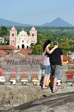 Couple enjoying the view from Cathedral to Iglesia de la Asuncion, Leon, Nicaragua, Central America Couple enjoying the view from Cathedral to Iglesia de la Asuncion, Leon, Nicaragua, Central America