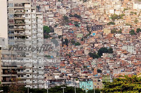 South America, Rio de Janeiro, Rio de Janeiro city, view of apartment blocks in Sao Conrado standing in front of the breeze block houses of Rocinha favela