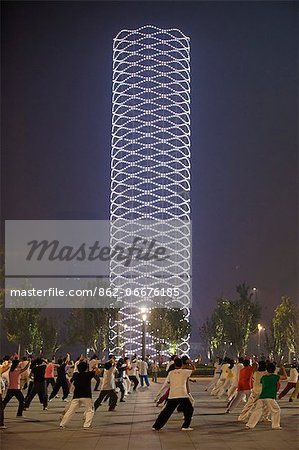 China, Tianjin. People performing Tai Chi in Yinhe Park at night.