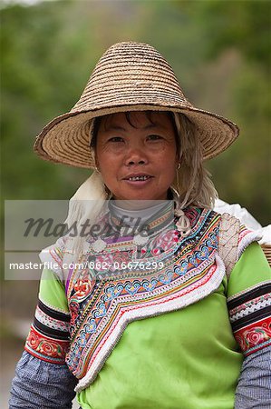 China, Yunnan, Yuanyang. A Hani lady returning from planting rice.