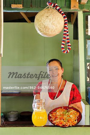 Central America, Costa Rica, Woman in restaurant showing a traditional dish