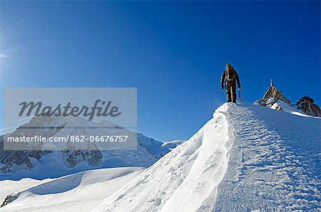 Europe, France, French Alps, Haute-Savoie, Chamonix, Aiguille du Midi, climber walking on the ridge Europe, France, French Alps, Haute-Savoie, Chamonix, Aiguille du Midi, climber walking on the ridge