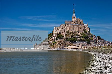 Mont Saint Michel and its connection to the mainland via a tidal causeway with the River Couesnon on the left at high tide, Le Mont Saint Michel, Basse Normandie, France.