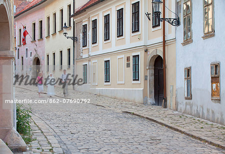 People walking along Kapitulska Street in Old Town, Bratislava, Slovakia