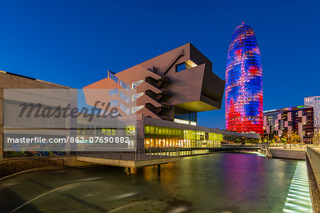Design Museum or Museu del Disseny with Torre Agbar behind at night, Barcelona, Catalonia, Spain