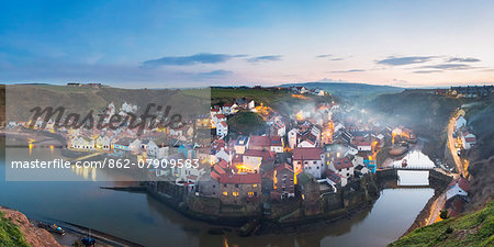 United Kingdom, England, North Yorkshire, Staithes. The harbour seen at dusk from Cowbar Nab.
