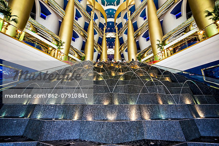 The multicoloured entrance lobby and fountain detail of the 7 star Burj Al Arab Hotel designed by the architects Atkins, Um Suqaim Second, Dubai, The United Arab Emirates.