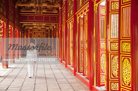 Woman wearing Ao Dai dress in Imperial Palace inside Citadel, Hue, Thua Thien-Hue, Vietnam (MR) Woman wearing Ao Dai dress in Imperial Palace inside Citadel, Hue, Thua Thien-Hue, Vietnam (MR)