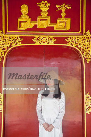 Woman wearing Ao Dai dress in Imperial Palace inside Citadel, Hue, Thua Thien-Hue, Vietnam (MR) Woman wearing Ao Dai dress in Imperial Palace inside Citadel, Hue, Thua Thien-Hue, Vietnam (MR)